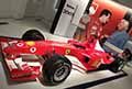 Monoposto Formula 1 Ferrari F2003 GA esposta allOfficina Alfonso Ferrari con la gigantografia di Gianni Agnelli che parla con Michael Schumacher del 1997 al Museo Ferrari di Modena